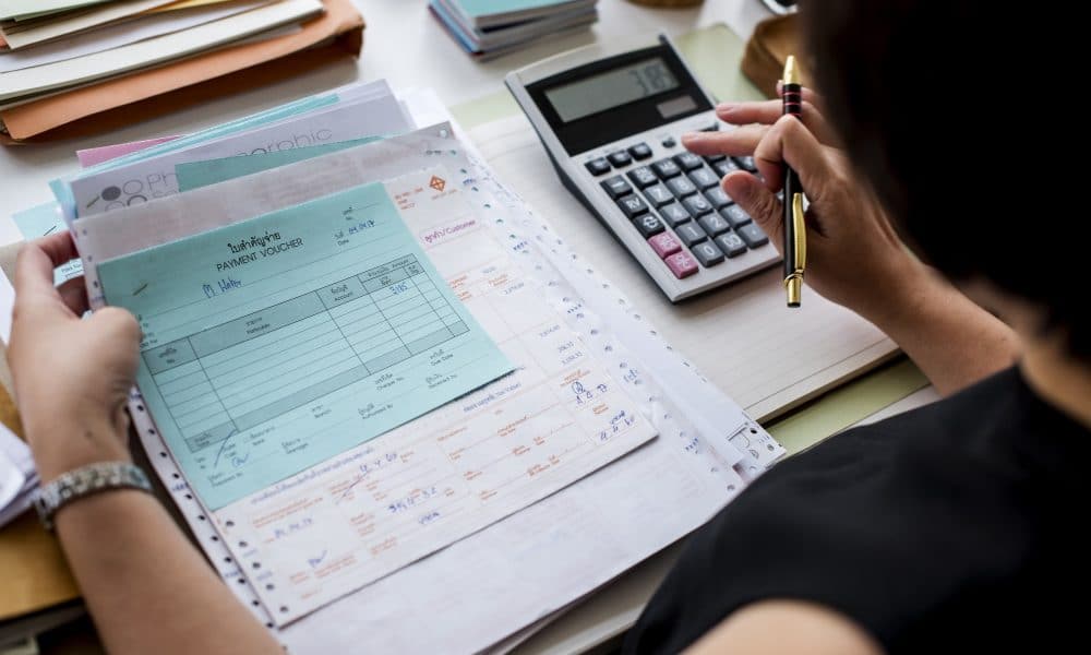 Adult asian woman working on payment bills accounting summary da